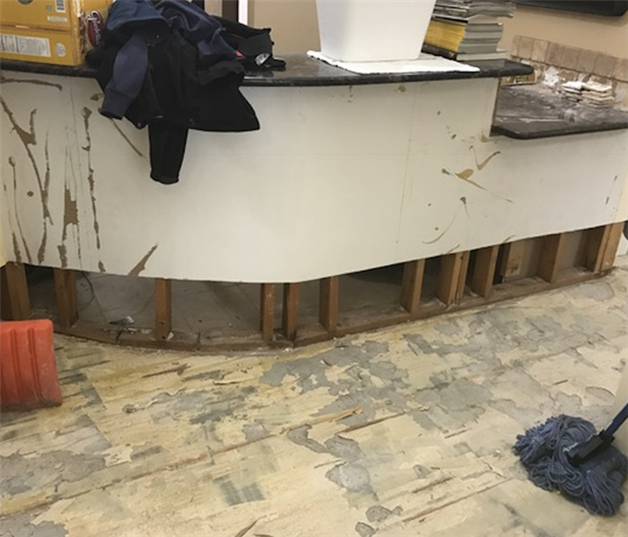 Flood cuts to front desk of office.