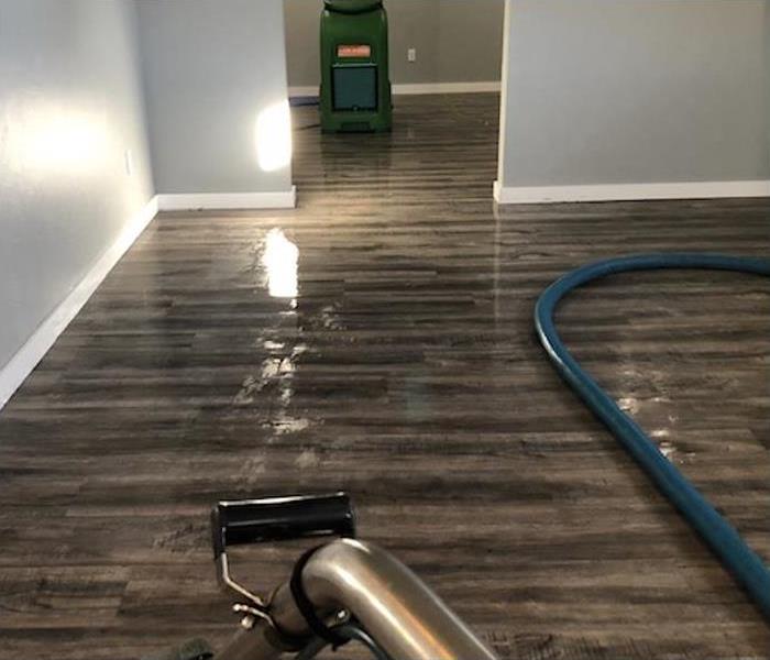 wet wooden floor, humidifier and a vacuum extractor. Concept water damage